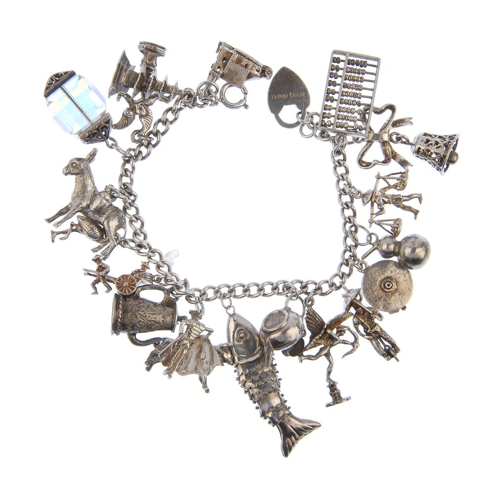 Two charm bracelets.: Two charm bracelets. The curb-link bracelets suspending a total of forty-six charms, to include a compass and a telephone, one with a heart padlock clasp and safety chain, one with a spring-release cl