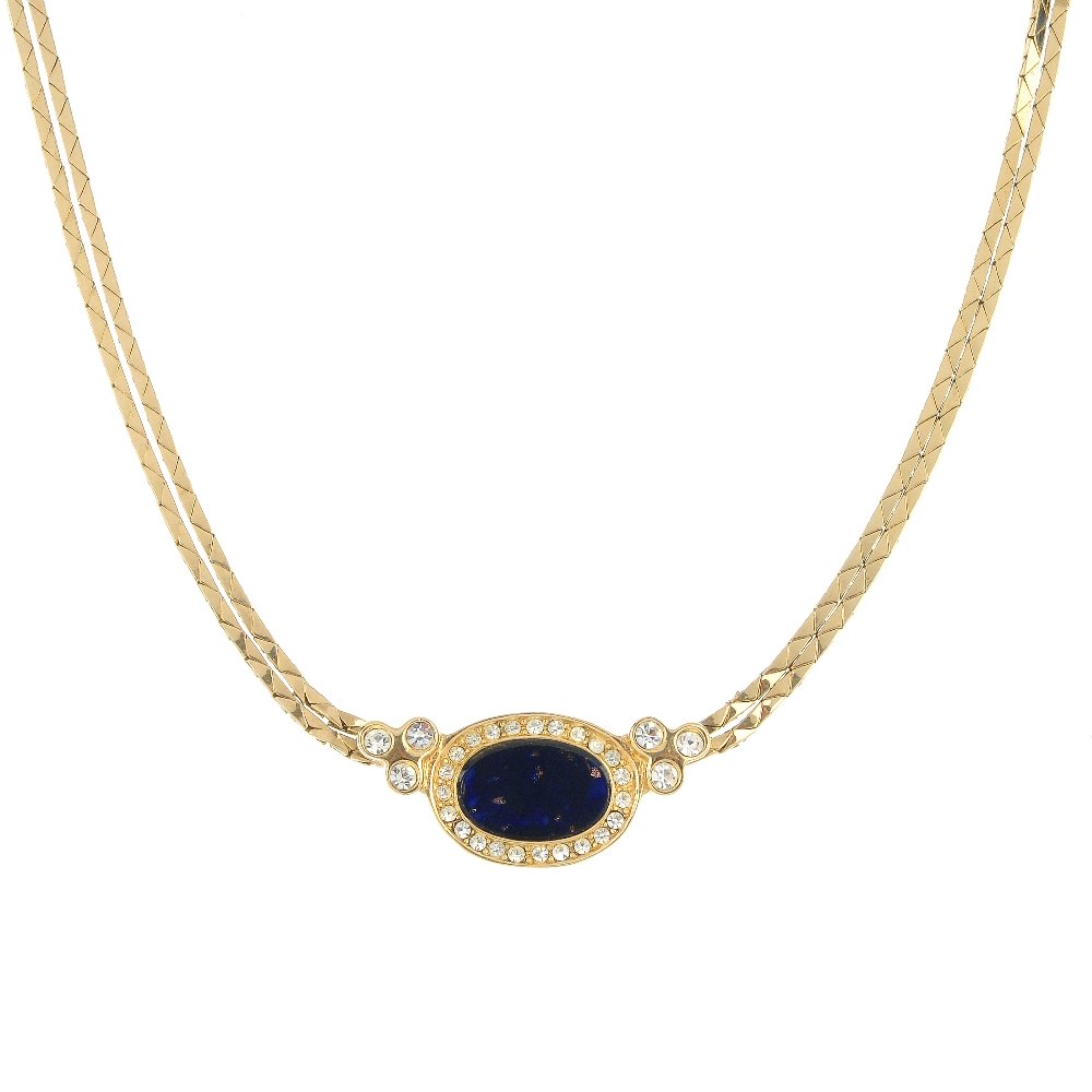 CHRISTIAN DIOR - two necklaces. One with maker's pouch.: CHRISTIAN DIOR - two necklaces, the first designed as an oval-shape blue and colourless paste panel to the double chain, together with an oval pendant suspended from a rope-twist chain. Both signed Ch