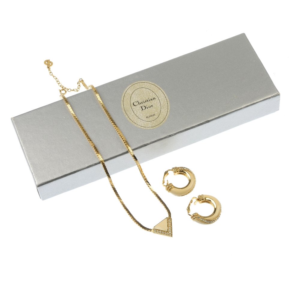CHRISTIAN DIOR - an enamel and paste necklace and ear: CHRISTIAN DIOR - an enamel and paste necklace and ear hoop set. The necklace designed as a triangular-shape cream enamel and colourless paste panel to the fancy-link chain, together with a pair of mat
