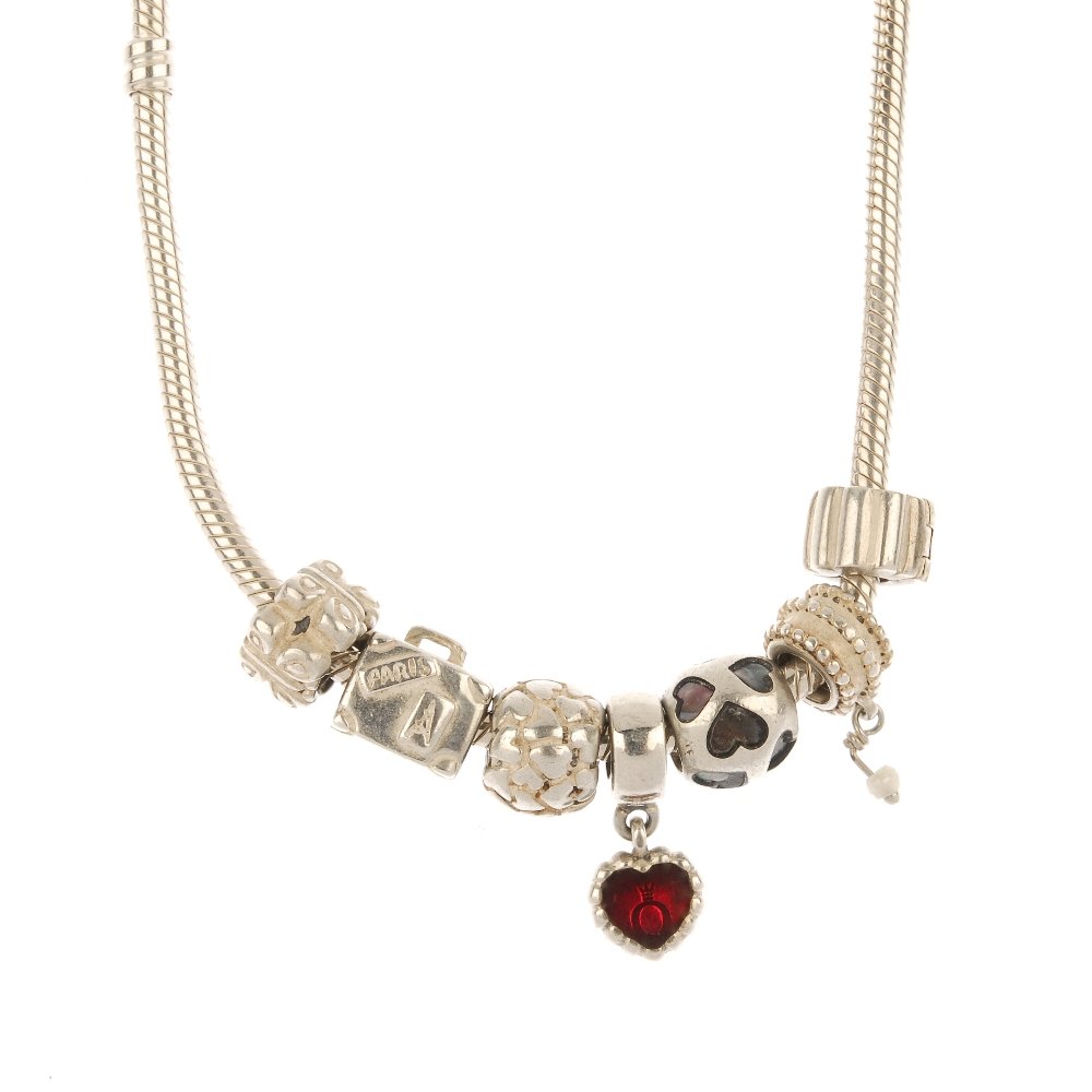 PANDORA - a necklace and seven charms.: PANDORA - a necklace and seven charms. The snake-link chain necklace, together with seven charms, to include a suitcase, a butterfly motif charm and a red enamel heart. Maker's mark for Pandora. Lengt