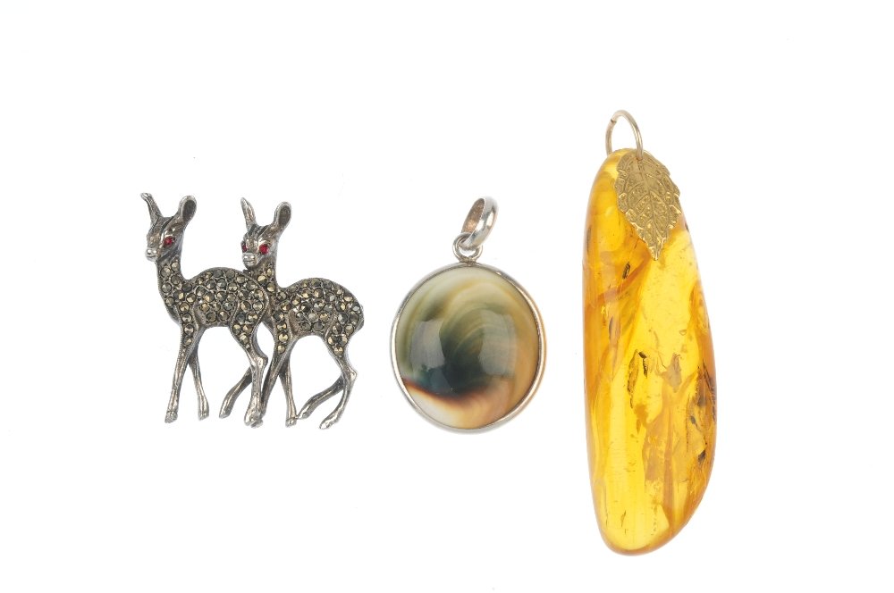 Two costume jewellery items and a pressed amber: Two costume jewellery items and a pressed amber pendant, to include a marcasite and red-paste novelty brooch, an operculum pendant, together with a pressed amber pendant. One with marks indicating sil