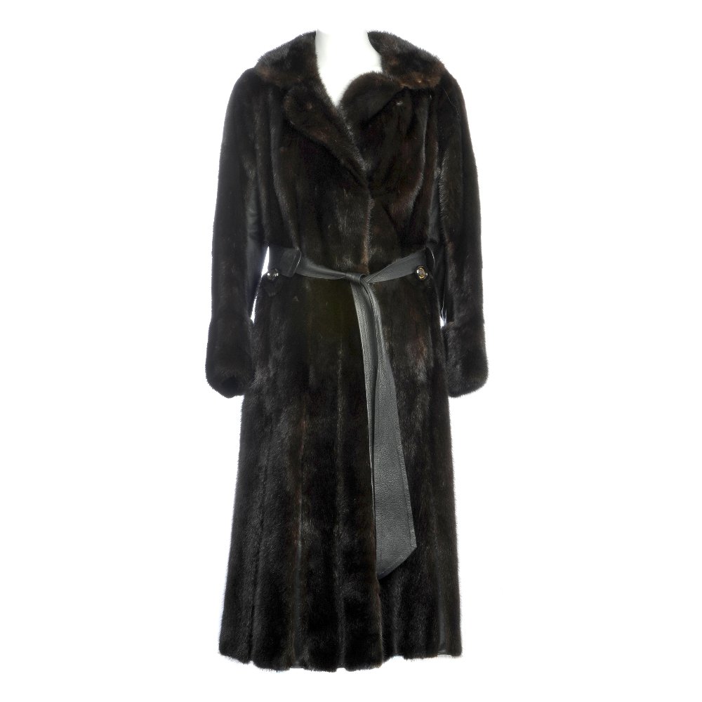 Full-length dark ranch mink coat: A full-length dark ranch mink panelled coat. Designed with a notched lapel collar, hook and eye fastenings, black leather trim and matching leather waist belt with buttoned details. Labelled Faulkes E