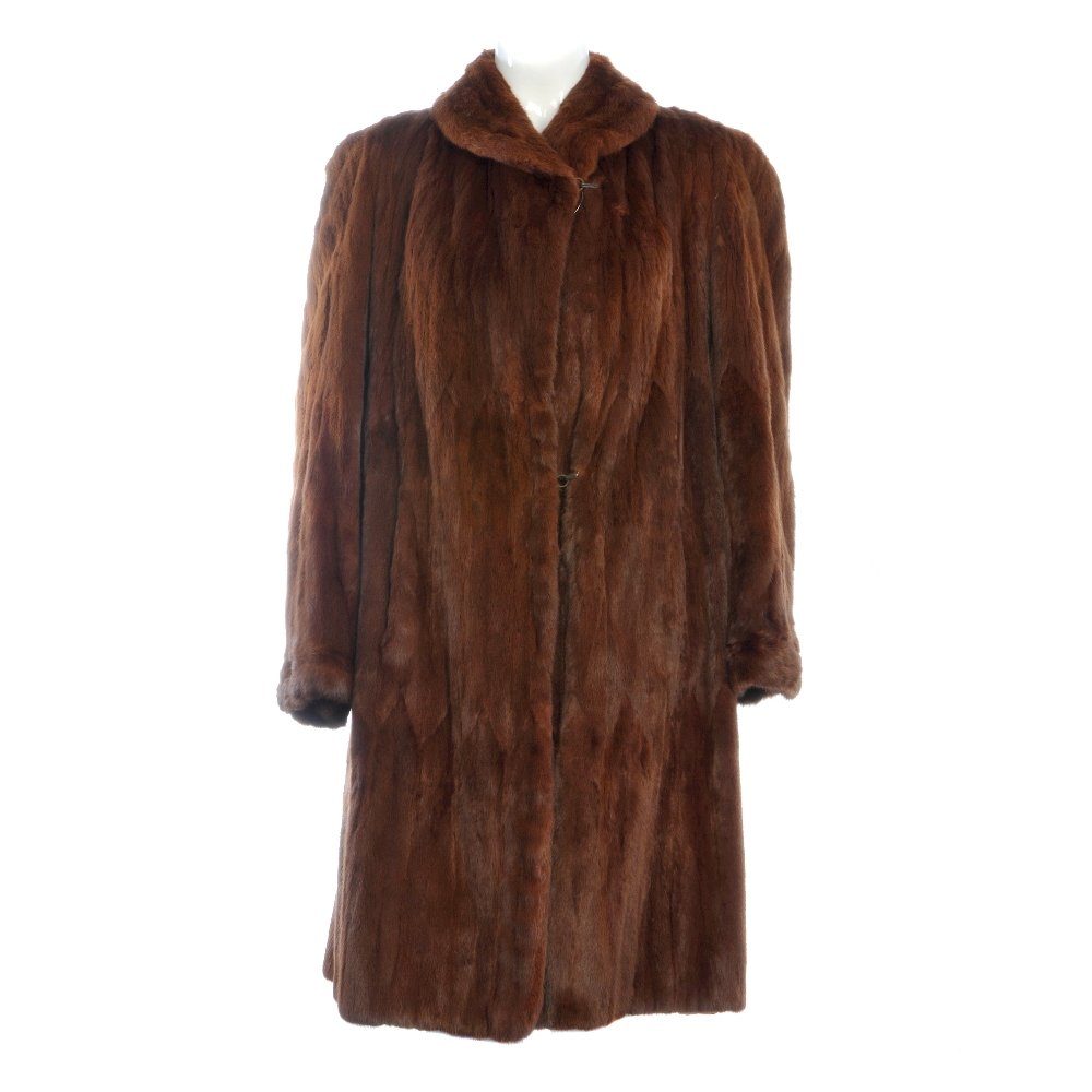 A dyed Russian ermine coat and a dyed Canadian squirrel: Two knee-length fur coats of a similar style. To include a dyed Russian ermine coat and a dyed Canadian squirrel coat, both featuring a lapel collar, hook and eye fastenings, wide sleeves and cocktail