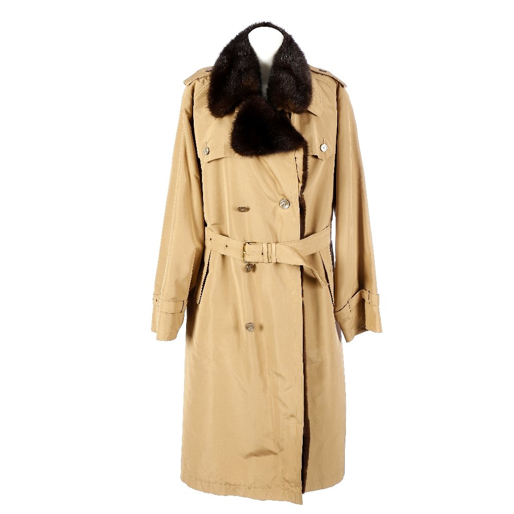 HERMES - a trench coat.: HERMES - a trench coat. Designed with a sheared dyed coypu lining and ranch mink notched lapel collar, double breasted button and waist belt fastening, single vent and deep back yoke.