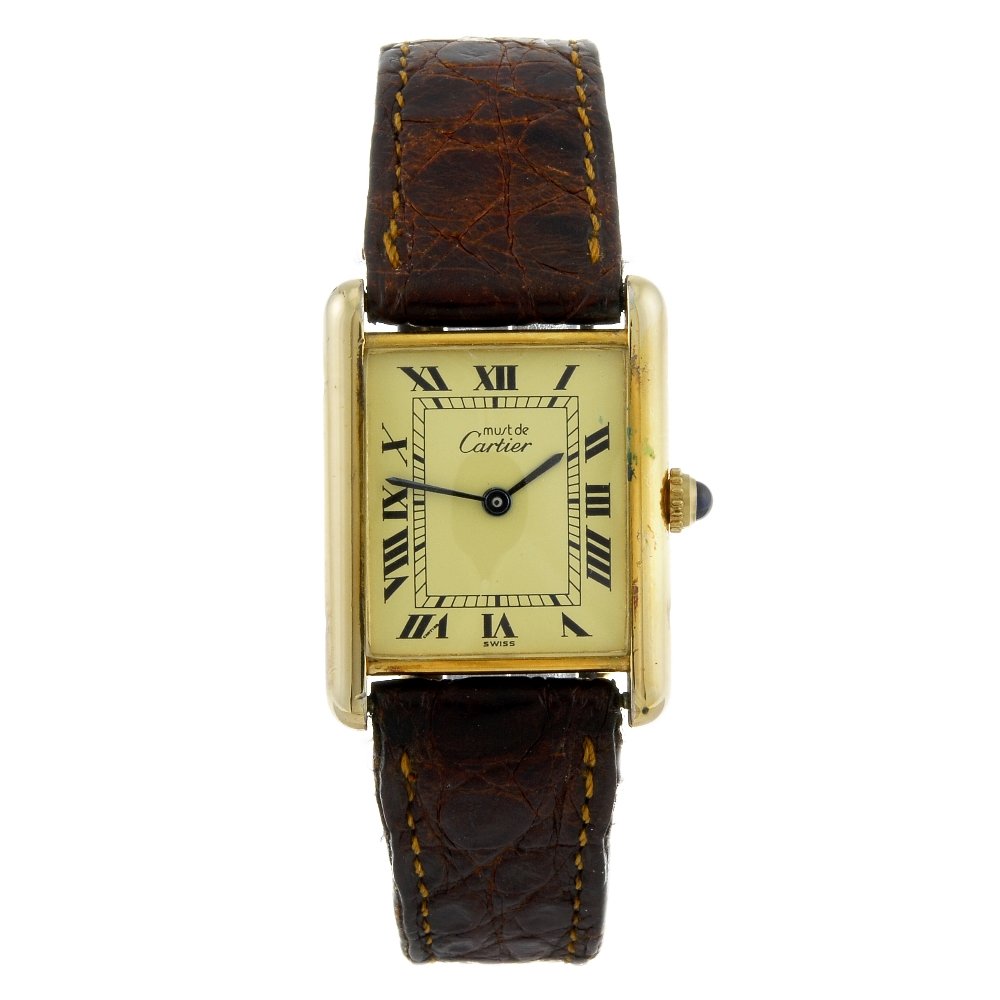 CARTIER - a gold plated silver Must de Cartier Tank: CARTIER - a Must de Cartier Tank wrist watch. Stamped 925. Numbered 71862 590005. Signed quartz calibre 90. Cream dial with Roman numeral hour markers. Gold plated silver case fitted to an unsigned br