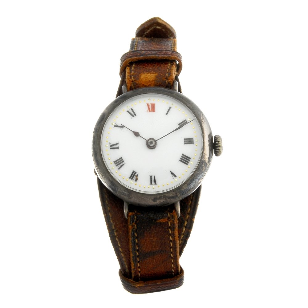 A lady's silver trench style wrist watch.: A lady's trench style wrist watch. Import hallmarked London 1913. Numbered 206506. Unsigned manual wind movement. White enamel dial with Roman numeral hour markers. Silver case fitted to an unsigned b