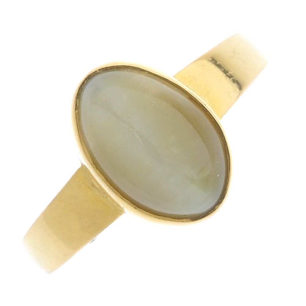 A cat's-eye chrysoberyl ring.: A cat's-eye chrysoberyl ring. The oval-shape cat's-eye chrysoberyl collet, to the tapered band. Weight 5gms.