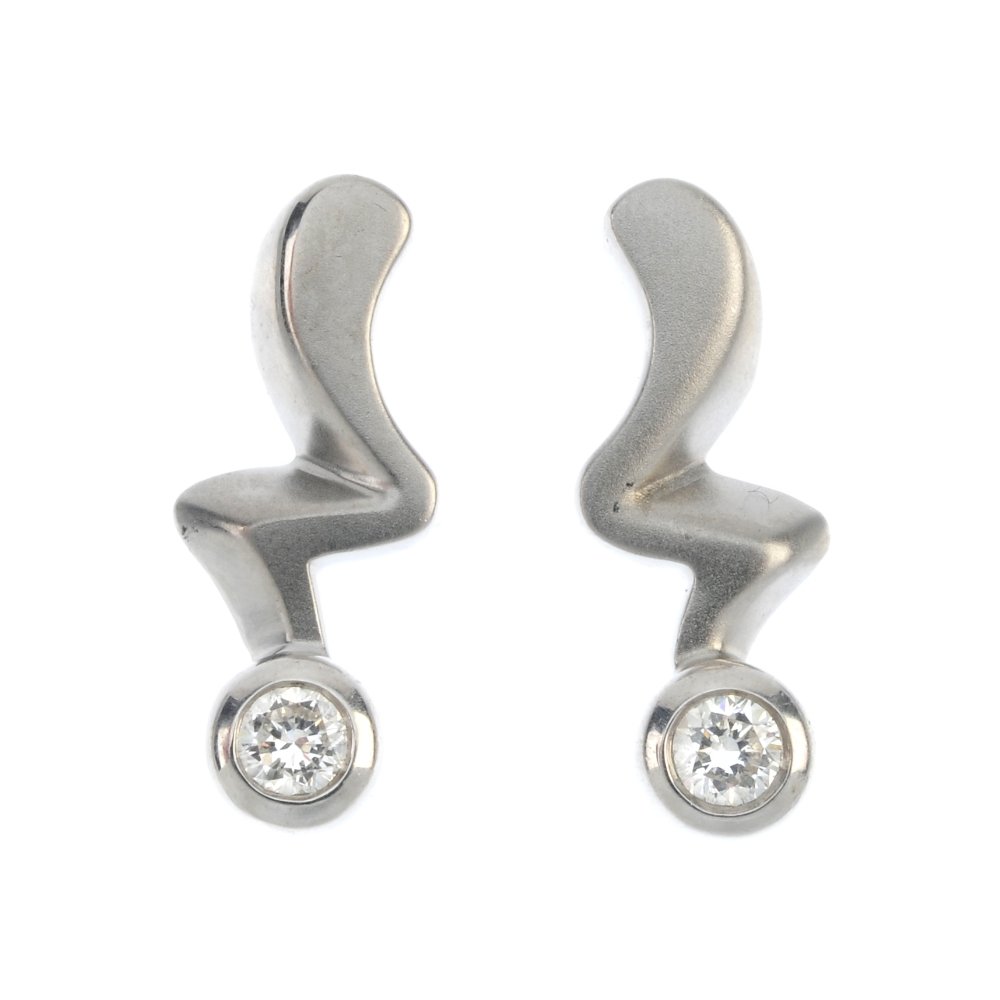A pair of 18ct gold diamond earrings.: A pair of 18ct gold diamond earrings. Each designed as an angular line, with brilliant-cut diamond collet terminal. Estimated total diamond weight 0.30ct. Hallmarks for London. Length 1.8cms. Weight 3