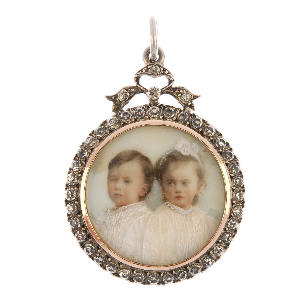 An early 20th century silver paste portrait miniature: An early 20th century silver paste portrait miniature pendant. Of circular outline, depicting two children, within a circular-shape colourless paste surround and bow surmount, to the glazed hair and f