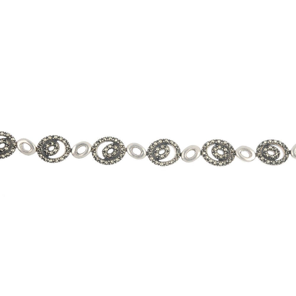 A selection of marcasite jewellery.: A selection of marcasite jewellery. To include a pair of geometric black paste and imitation pearl ear pendants, a spray brooch and a panel ring. (6) Three with marks indicating silver. Length of brac