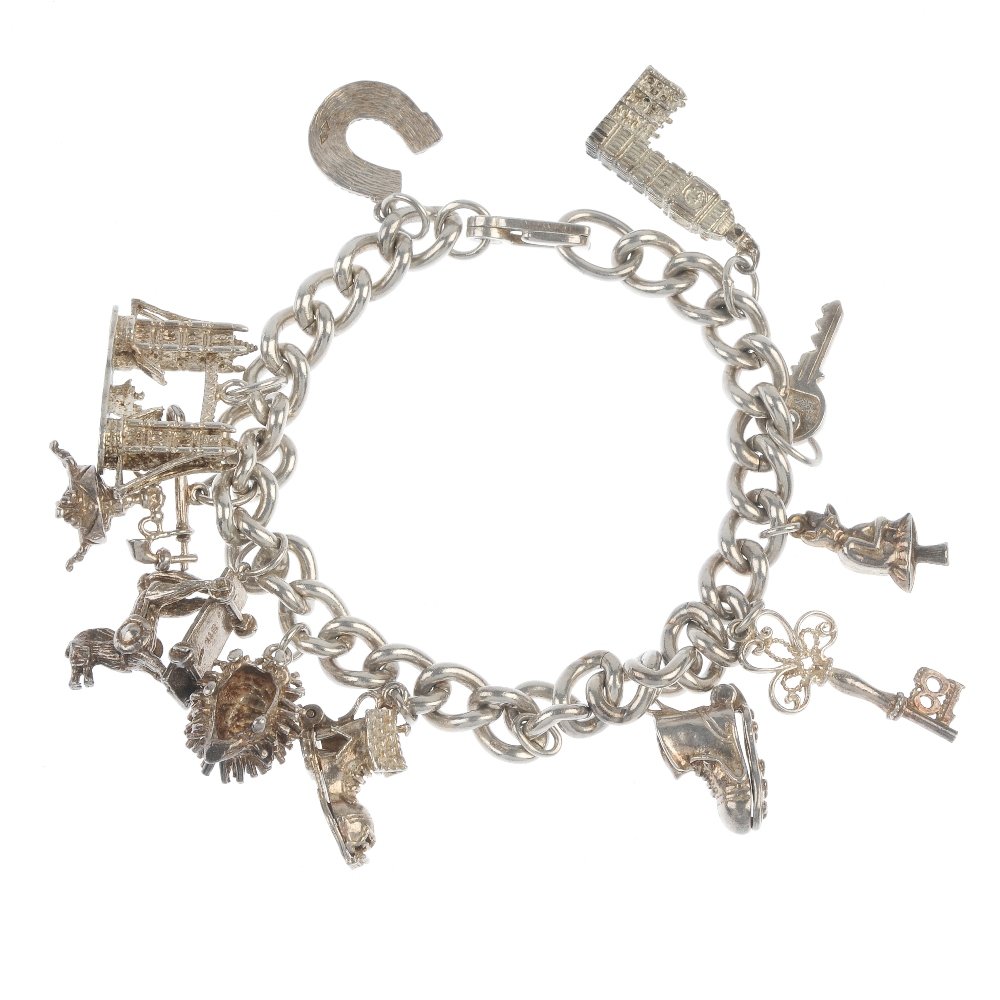 Three charm bracelets.: Three charm bracelets. To include a curb-link bracelet and two silver curb-link bracelets, suspending a total of twenty charms, to include a wishing well and a sewing machine. Two bracelets with hallm