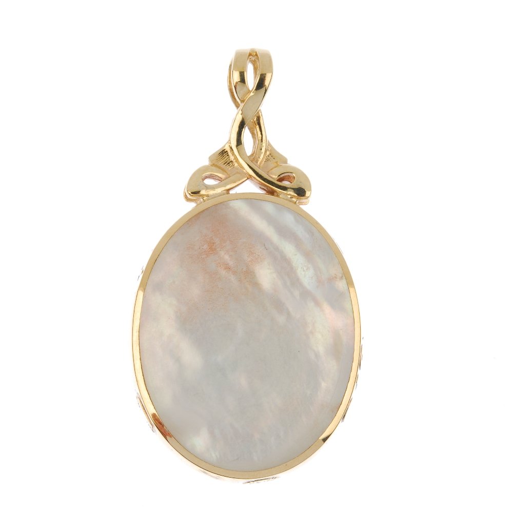A 9ct gold mother-of-pearl and goldstone double-sided: A 9ct gold mother-of-pearl and goldstone double-sided pendant. The oval mother-of-pearl and blue goldstone panels, to the openwork surmount. Sponsor's marks for David Scott Walker. Hallmarks for Sheff