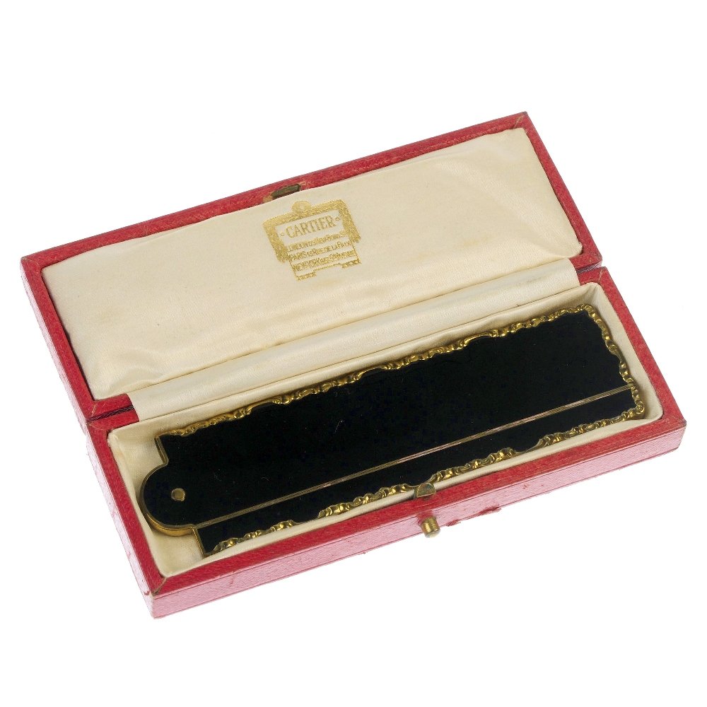 A Cartier box and a non designer comb.: A Cartier box and a non designer comb. The folding imitation tortoiseshell comb to the enamel and scrollwork casing together with the red leather Cartier box with gold coloured detailing and logo to t