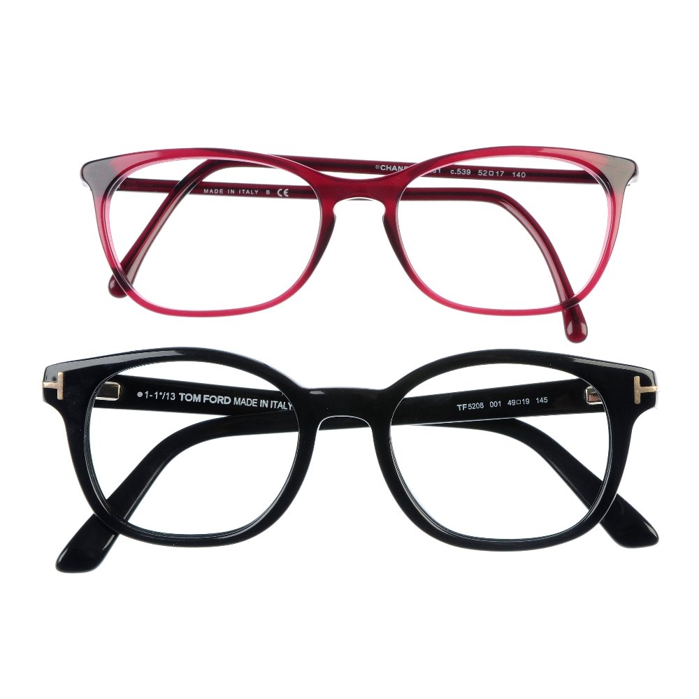 Two pairs of designer glasses frames.: Two pairs of designer glasses frames. To include a maroon coloured acetate pair by Chanel, featuring thin cat-eye shaped frames and maker's logo at each temple, together with a pair of similarly shape