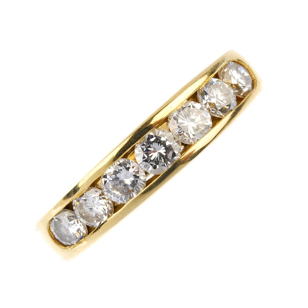 An 18ct gold diamond half-circle eternity ring.: An 18ct gold diamond half-circle eternity ring. The brilliant-cut diamond line, within a channel-setting, to the slightly tapered band. Total diamond weight 0.80ct, stamped to band. Hallmarks for Lond
