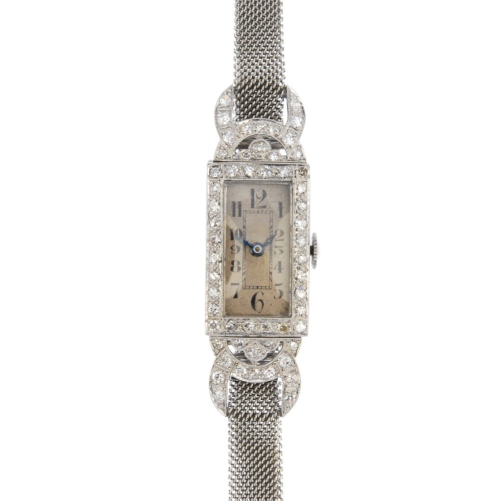 A lady's mid 20th century diamond cocktail watch.: A lady's mid 20th century diamond cocktail watch. The rectangular-shape silvered dial with black Arabic numerals and minute track, to the single-cut diamond bezel and geometric lugs, on a mesh adjusta