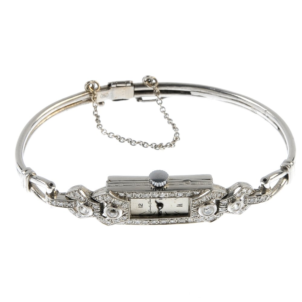A lady's 18ct gold diamond manual wind cocktail watch.: A lady's 18ct gold diamond manual wind cocktail watch. The rectangular-shape silvered dial, within the brilliant and single-cut diamond case, to the hinged bangle. Estimated total diamond weight 0.90c