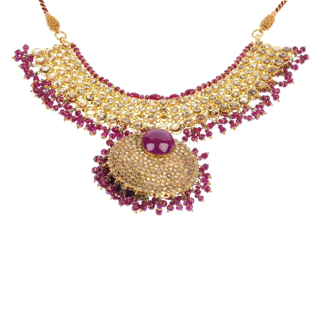 (6000446-1-A) A stone-set necklace on cord back chain.: (6000446-1-A) A stone-set necklace. The brown-tinted gem disc with treated red corundum cabochon accents and fringe, suspended from a similarly-set flexible panel, on cord back-chain. Total weight 150