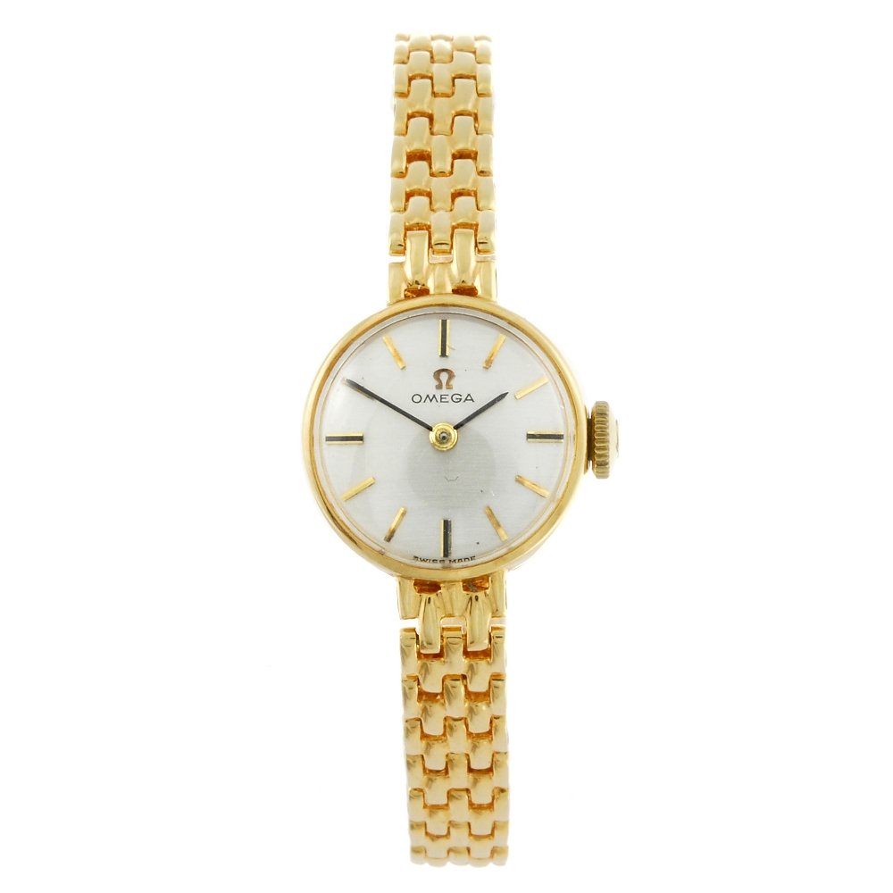 OMEGA - a lady's 9ct yellow gold bracelet watch.: OMEGA - a lady's bracelet watch. 9ct yellow gold case, hallmarked London 1963. Numbered 7115603. Signed manual wind calibre 483. Silvered dial with baton hour markers. Fitted to a signed yellow metal 