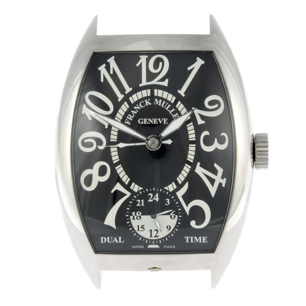 A dual time alarm clock by Franck Muller.: A dual time alarm clock by Franck Muller. Stainless steel case. Number 0150. Quartz movement. Black dial with Arabic numeral hour markers, second time zone dial to six. 86mm. Box and papers.