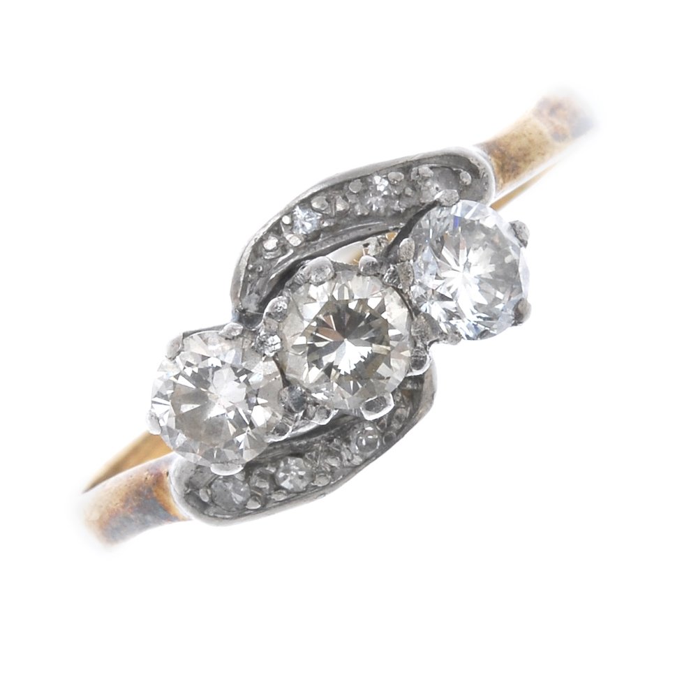 A diamond three-stone crossover ring. (1 of 4)