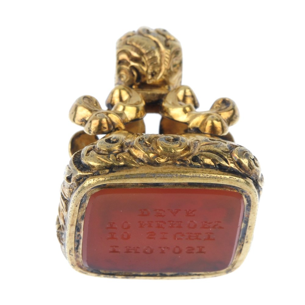 A late 19th century carnelian fob seal.: A late 19th century carnelian fob seal. The rectangular-shape carnelian, engraved 'Tho lost, to sight, to memory, dear', to the scrolling foliate and grooved pedestal. Length 3cms.