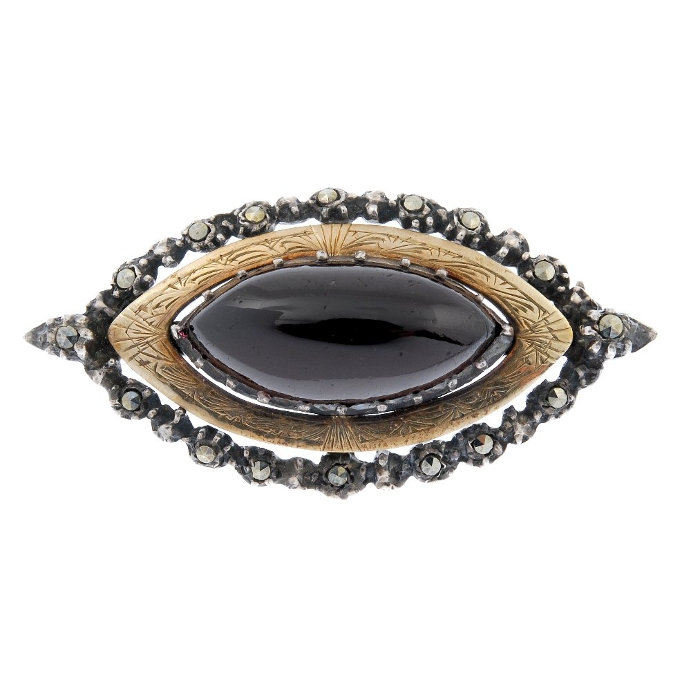 SIBYL DUNLOP - a silver garnet and marcasite brooch.: SIBYL DUNLOP - a silver garnet and marcasite brooch. The marquise-shape garnet cabochon, within a marcasite surround. Maker's marks for Sibyl Dunlop. Hallmarks for London, 1959. Length 4.6cms. Weight 