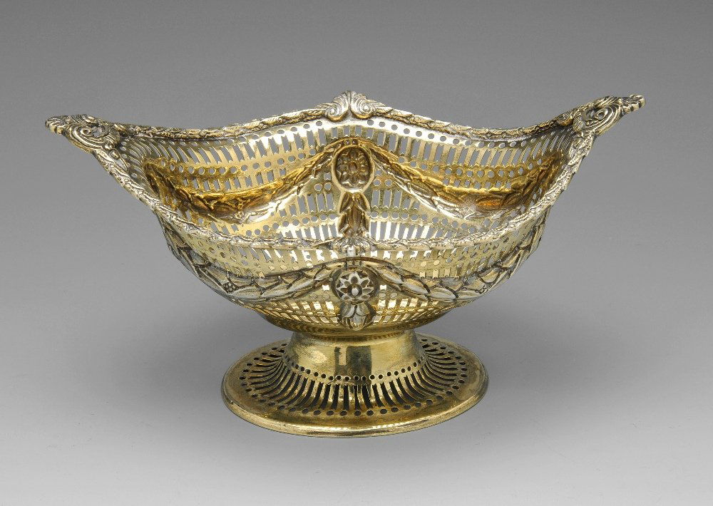 A late Victorian silver-gilt basket.: A late Victorian silver-gilt basket of navette form with lattice piercing and embossed swags. Hallmarked Charles Stuart Harris, London 1897. Maximum length measuring 7 inches (18 cm), weight 5.8 ozt (