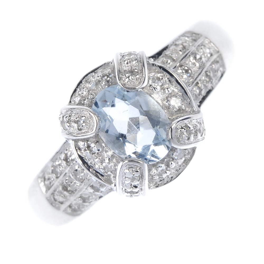 A 9ct gold aquamarine and diamond cluster ring. (1 of 4)