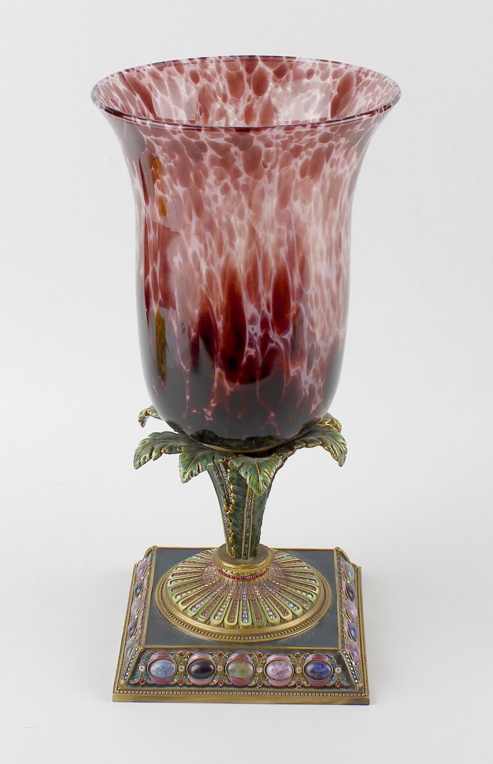 A large glass vase by Jay Stonewater.: A large glass vase by Jay Stonewater, the flaring bowl of mottled purple and clear glass raised upon sprouting acanthus leaf stem and further stone and gem set square base, having applied plaque benea