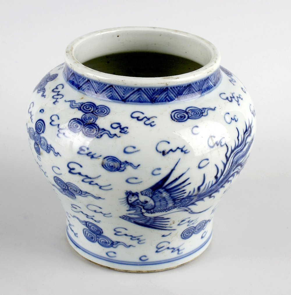 A Chinese porcelain blue and white baluster vase.: A Chinese porcelain blue and white baluster vase. Probably 18th century With chevron-decorated collar over dragon and phoenix chasing the flaming pearl of wisdom amidst clouds, 'Tian' mark and double 