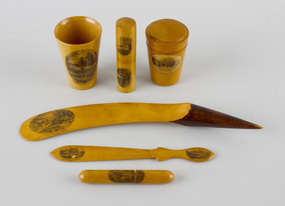 A small collection of Mauchline ware items.: A small collection of Mauchline ware items, comprising a beaker of tapering form plus another with cover, a shoe horn, letter opener, and two needle cases. (6).