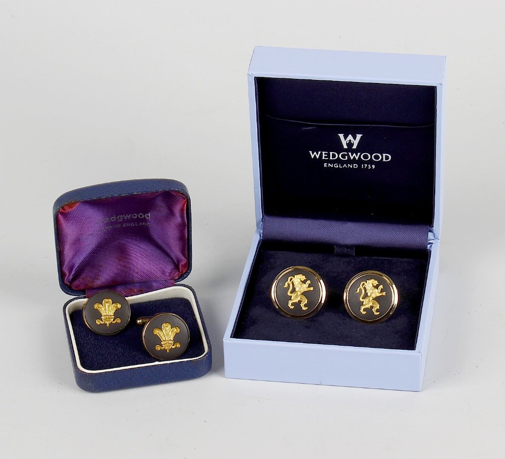 Two pairs of Wedgwood intaglio cufflinks.: Two pairs of Wedgwood intaglio cufflinks, the first having gilt lion motif on a black ground, 1", (2.5cm) diameter, the second similar having plume of feathers motif, 0.9", (2.25cm) diameter, each in 