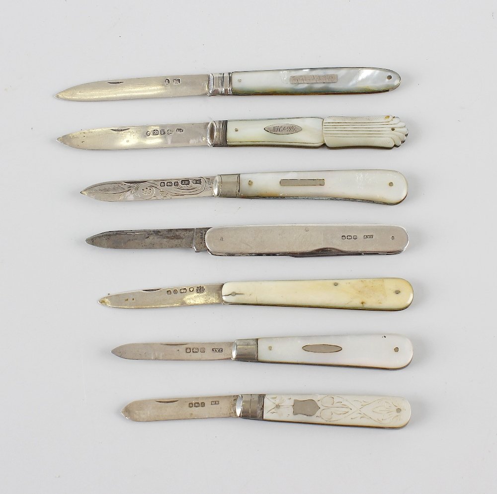 A group of seven silver bladed fruit knives.: A group of seven silver bladed fruit knives, each with folding blade and mother of pearl veneered handle. Together with another similar silver cased knife having three steel folding blades. (a/f).