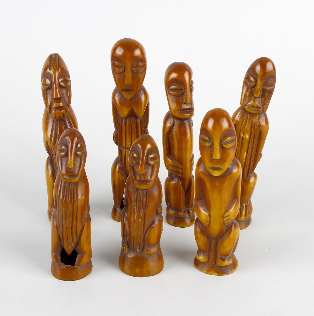 A good group of African patinated ivory figures: A good group of African patinated ivory figures Probably Lega, Congo, 19th century Comprising nine figures in various standing, seated and haunched poses, each with stylised almond-shaped face with sp