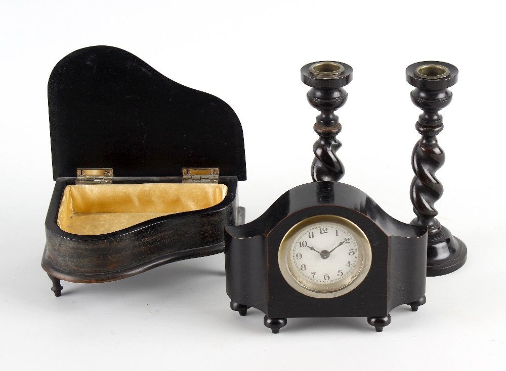 An ebony desk and dressing table suite.: An ebony desk and dressing table suite, comprising a letter tray, desk clock, pair of barley twist candlesticks, plus a hand mirror, hair bush and two clothes brushes, together with a jewellery box mo