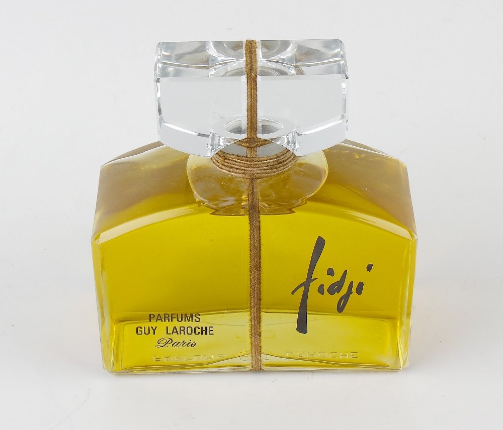 A large Guy Laroche 'Fidji' presentation perfume bottle: A large Guy Laroche 'Fidji' presentation perfume bottle, 32 fl. oz., unopened with original cord fastening and apparently at original fill level, 7", (18cm) high.