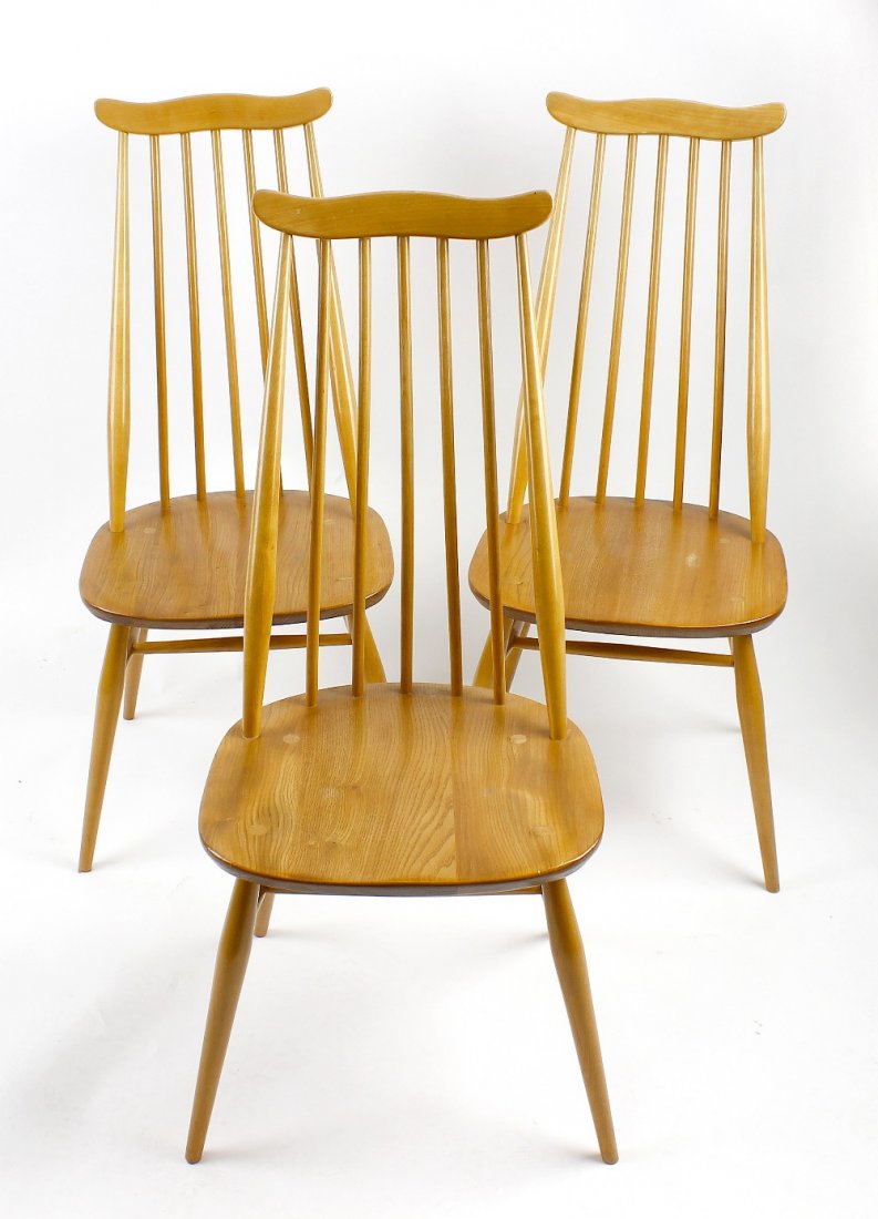 Two sets of three Ercol light oak chairs: Two sets of three Ercol light oak chairs. Comprising three standard dining chairs each with wavy toprail on splayed legs with H-stretcher, and three easy armchairs of similar period, (6)