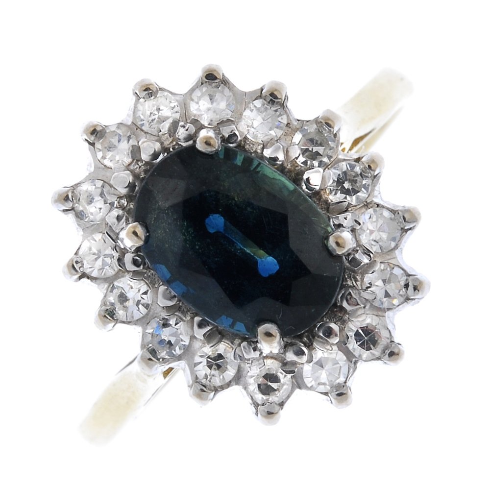 An 18ct gold sapphire and diamond cluster ring. (1 of 4)