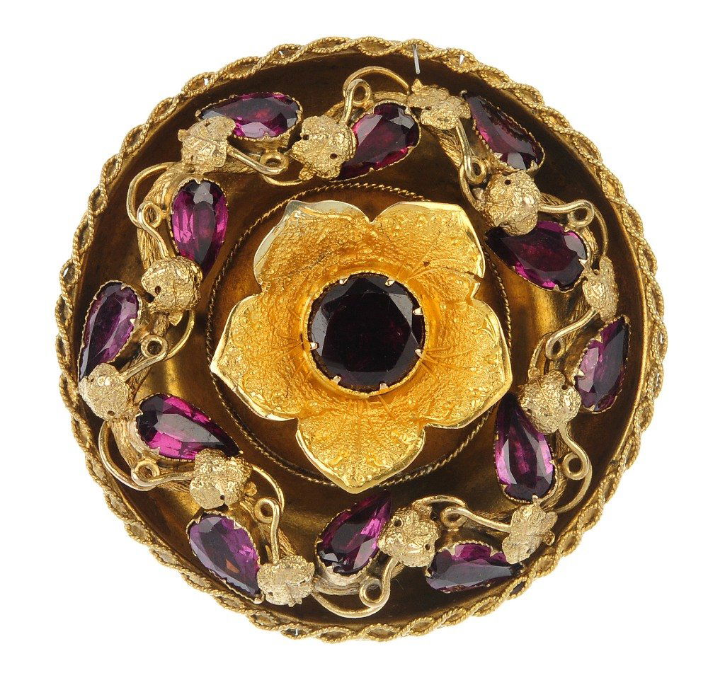 A mid 19th century gold garnet floral brooch. (1 of 2)