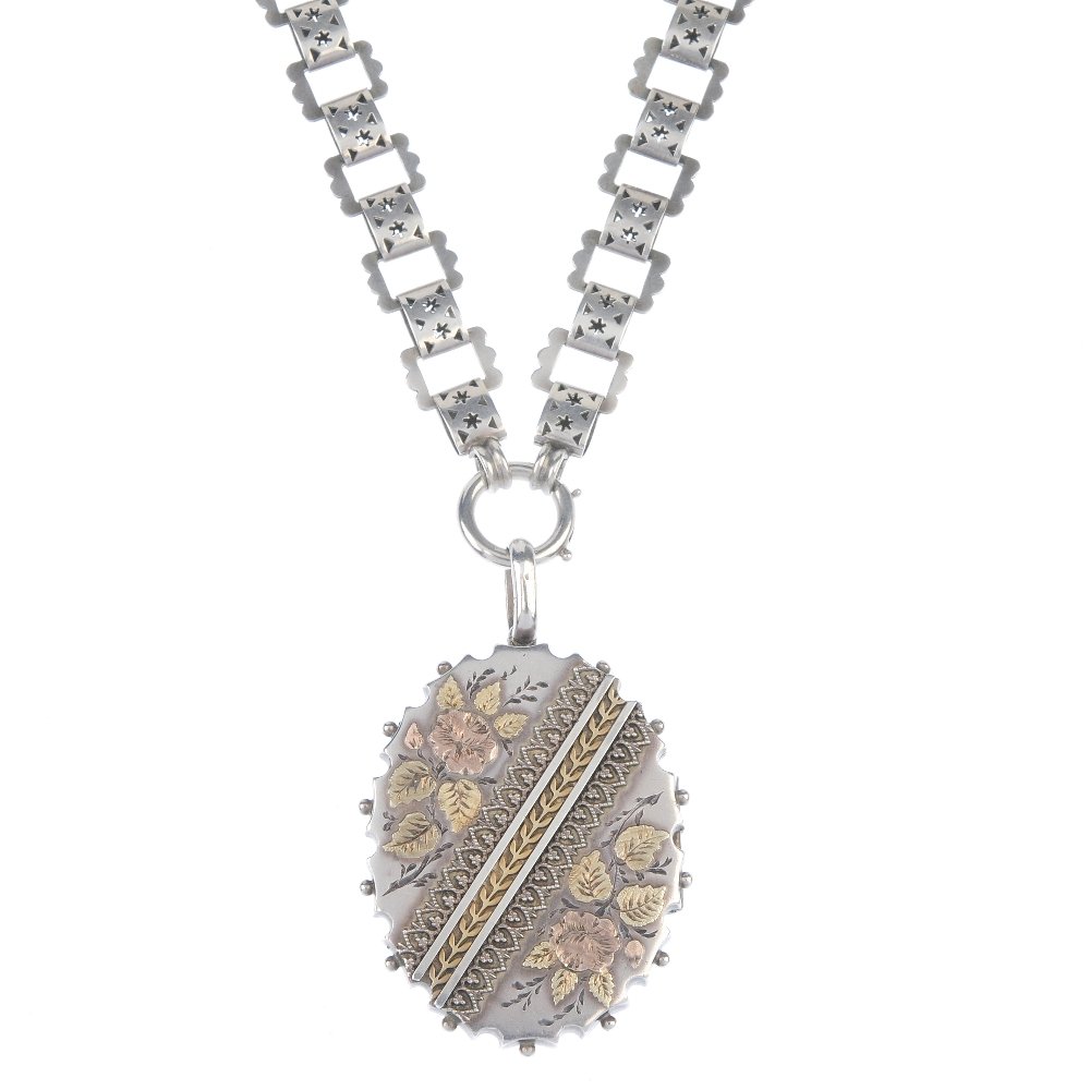 A late Victorian silver locket with chain. (1 of 3)