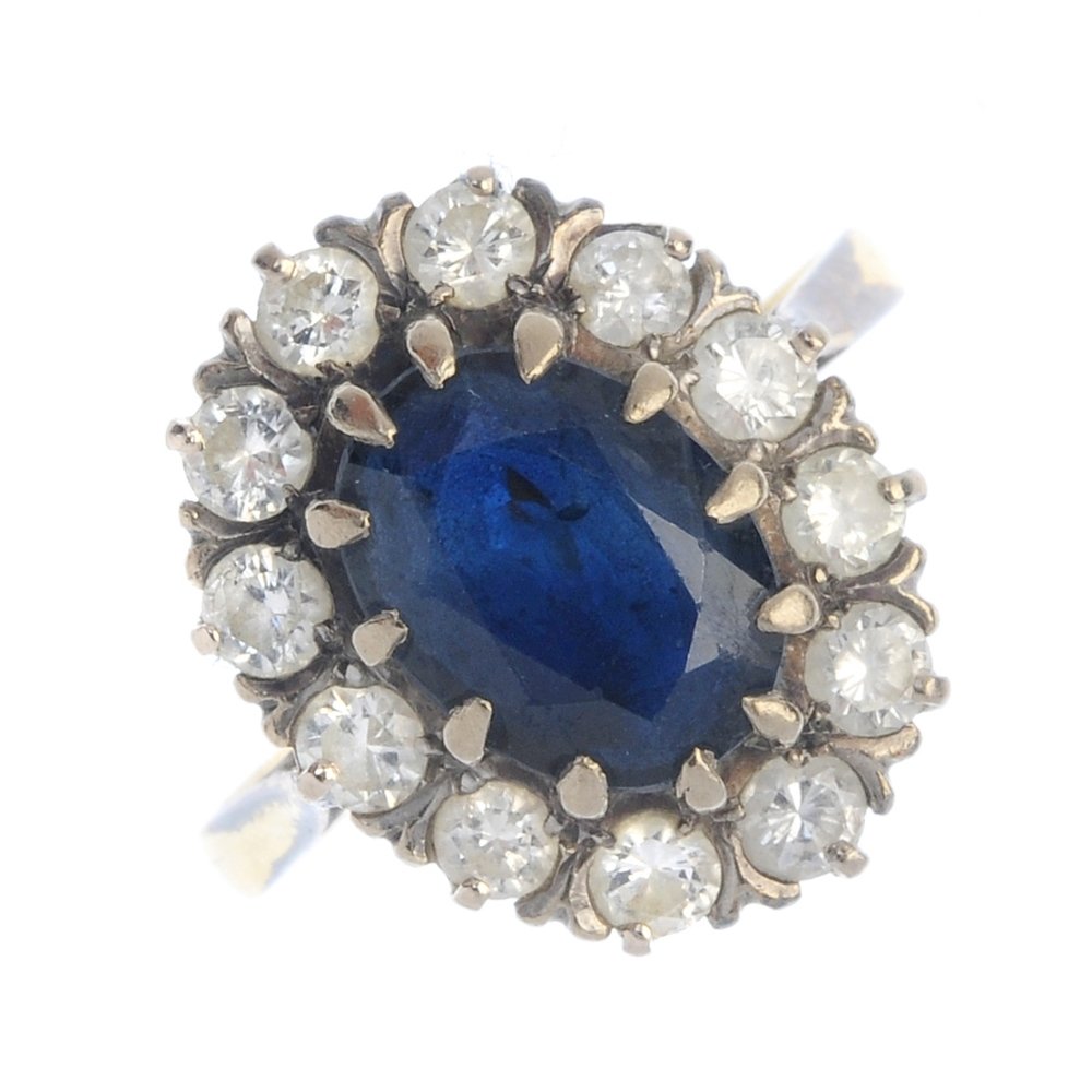 An 18ct gold sapphire and diamond cluster ring. (1 of 3)