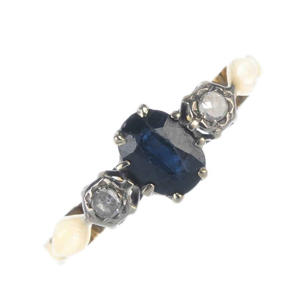 An 18ct gold sapphire and diamond three-stone ring. (1 of 4)