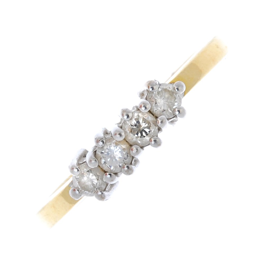 An 18ct gold diamond four-stone ring. (1 of 4)