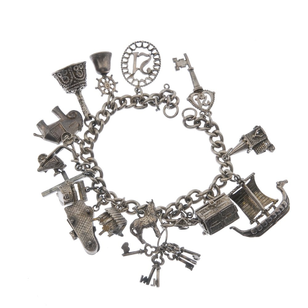 Two silver charm bracelets, with silver and white metal: Two silver charm bracelets, with silver and white metal charms. The two curb-link bracelets, suspending a total of thirty-three charms to include a rocking horse, a hedgehog and a camera. Bracelets wi