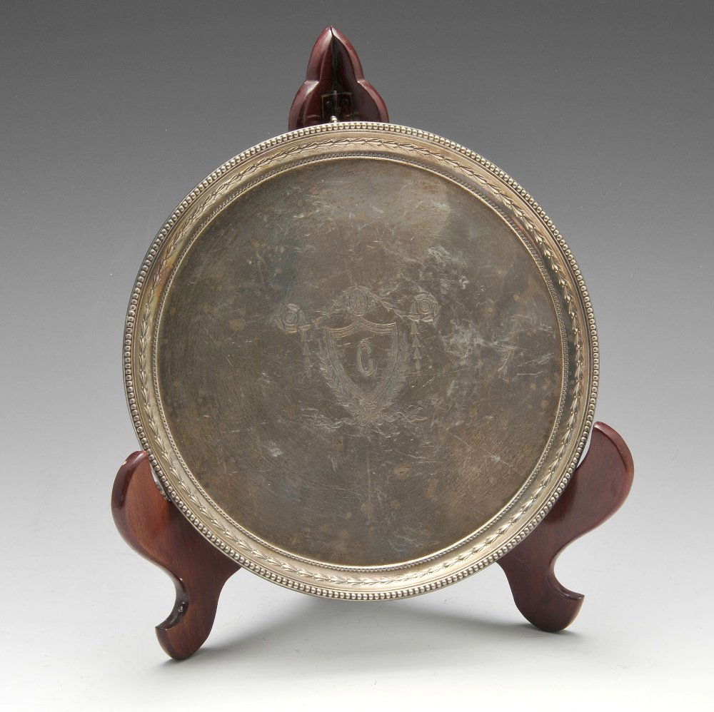 An Edwardian silver salver.: An Edwardian silver salver, the circular form with raised beaded edge, central initialled cartouche and standing on three claw and ball feet. Hallmarked James Dixon & Sons Ltd, Sheffield 1906, numbere