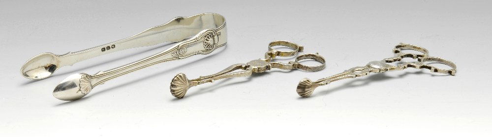A pair of George IV sugar tongs, plus a further two: A pair of George IV sugar tongs, having shell moulding to stems leading to further detail upon bowls, hallmarked John & Henry Lias, London 1820, length measures 6 inches (15.25 cm). Together with anot