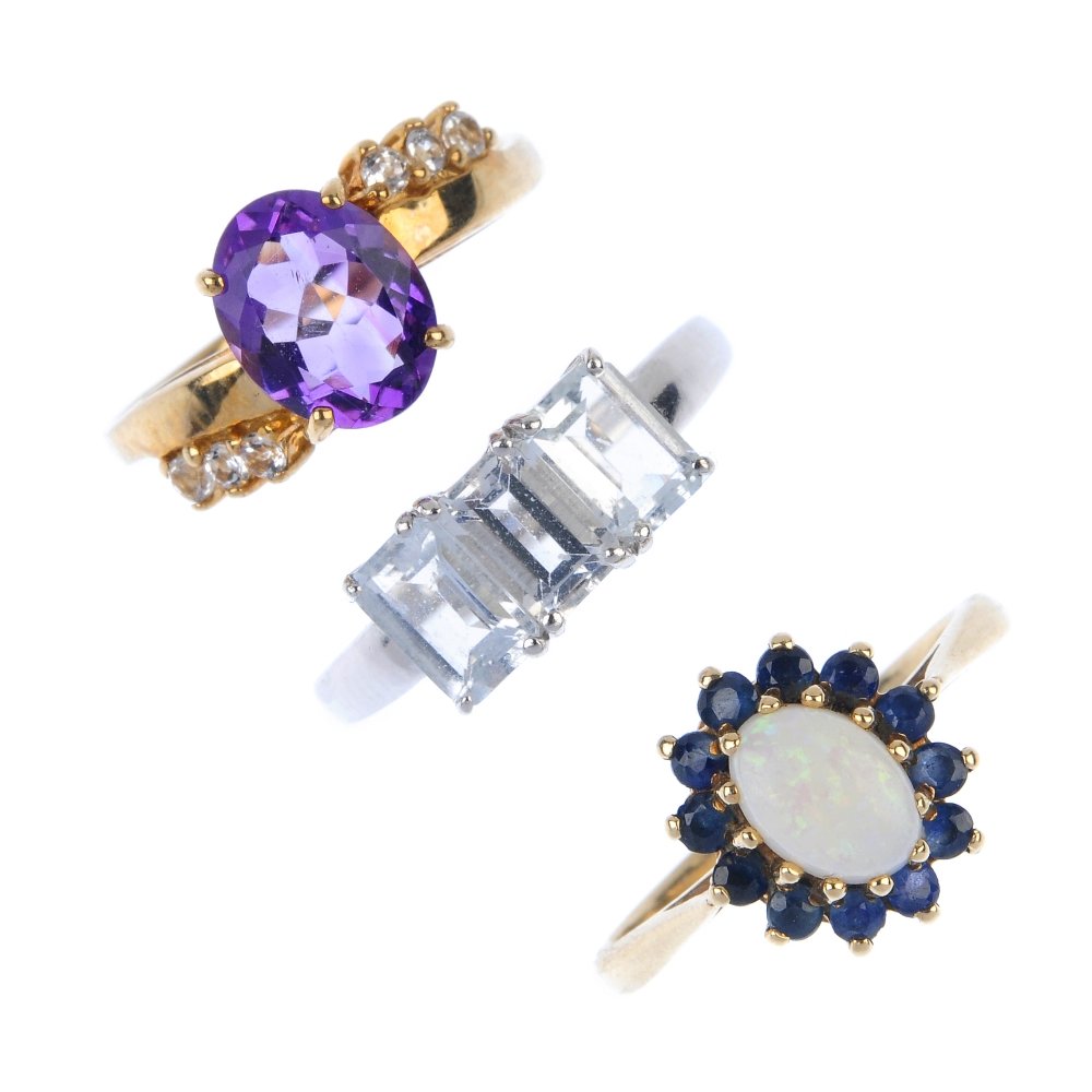 A selection of four 9ct gold gem-set dress rings. (1 of 3)