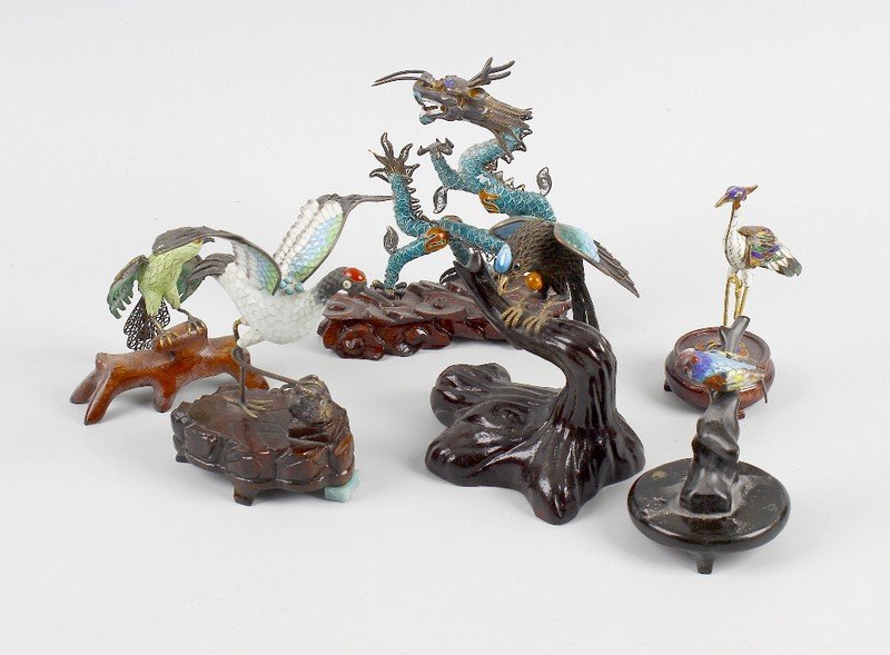A group of assorted cloisonne animal figures, etc.: A group of assorted cloisonne animal figures, variously modelled as a dragon, crane and other birds each raised upon wooden base, largest 5.25" (13.5 cm) high. Together with a group of assorted enamel