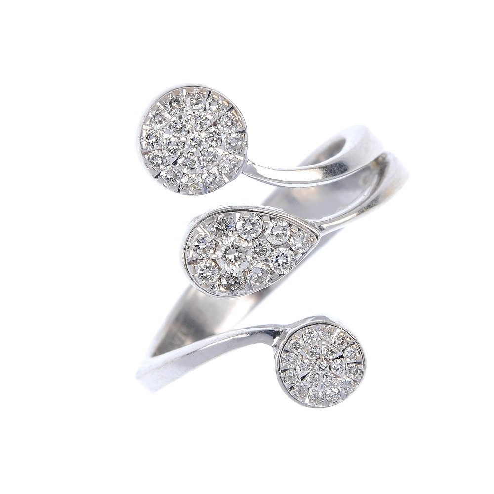 CHIMENTO - a diamond triple cluster ring.: CHIMENTO - a diamond triple cluster ring. Designed as a brilliant-cut diamond pear-shape cluster, with similarly designed circular-shape clusters sides, to the tapered band. Signed Chimento. Estimated